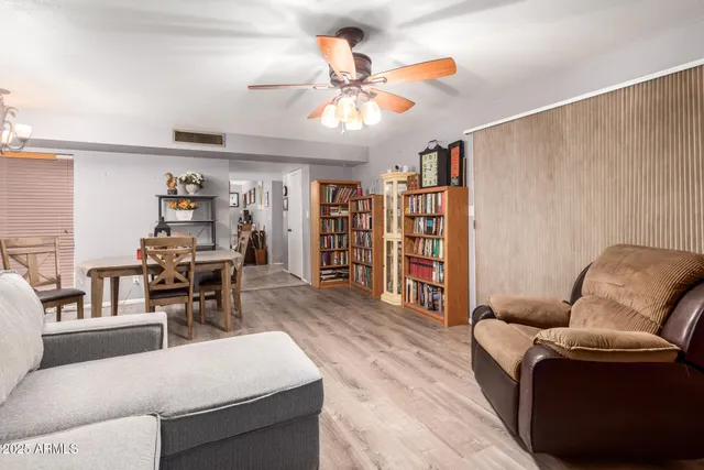 a living room with furniture and wooden floor