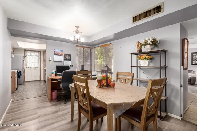 a view of a dining room with furniture and wooden floor