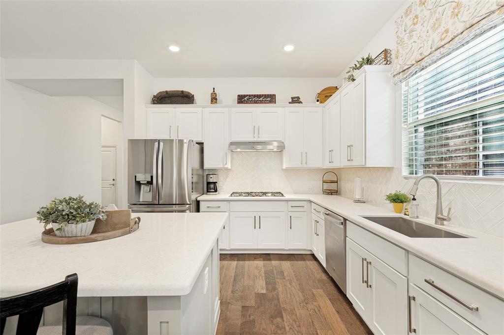 229 Savannah Lane Oak Point, TX 75068 - Photo 4 of 26 a kitchen with stainless steel appliances granite countertop a sink and cabinets