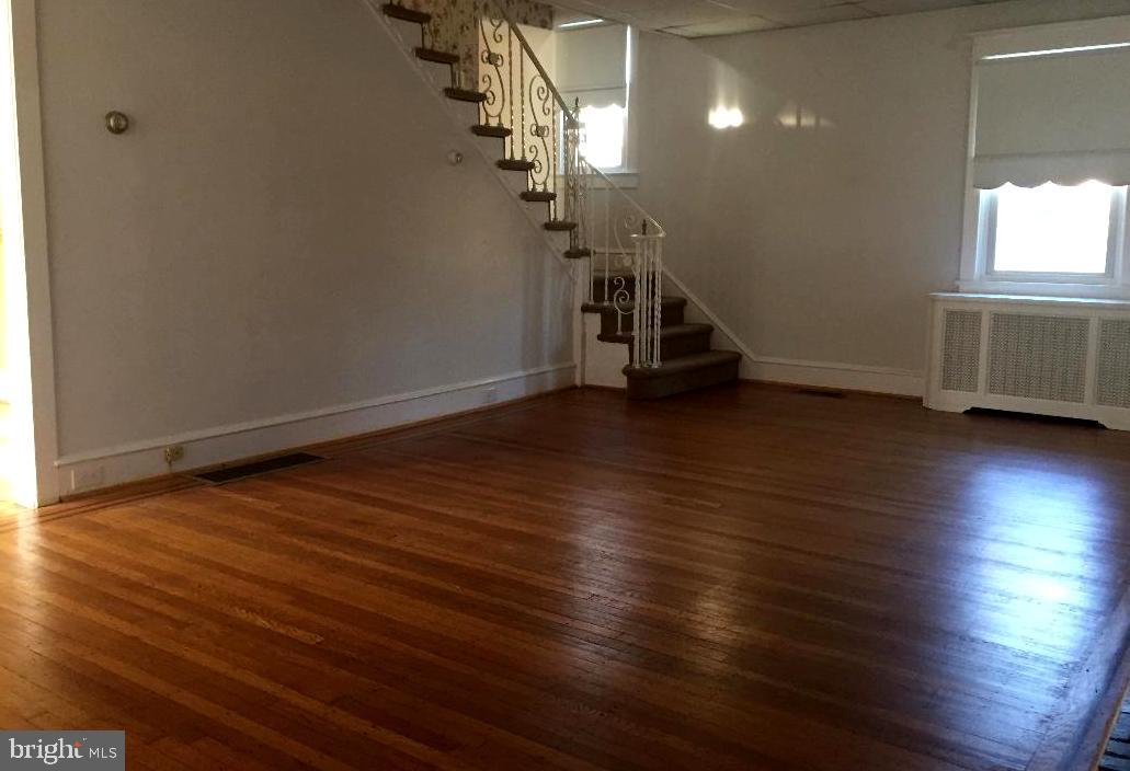 336 East Manoa Road Havertown, PA 19083 - Photo 6 of 23 an empty room with wooden floor and staircase