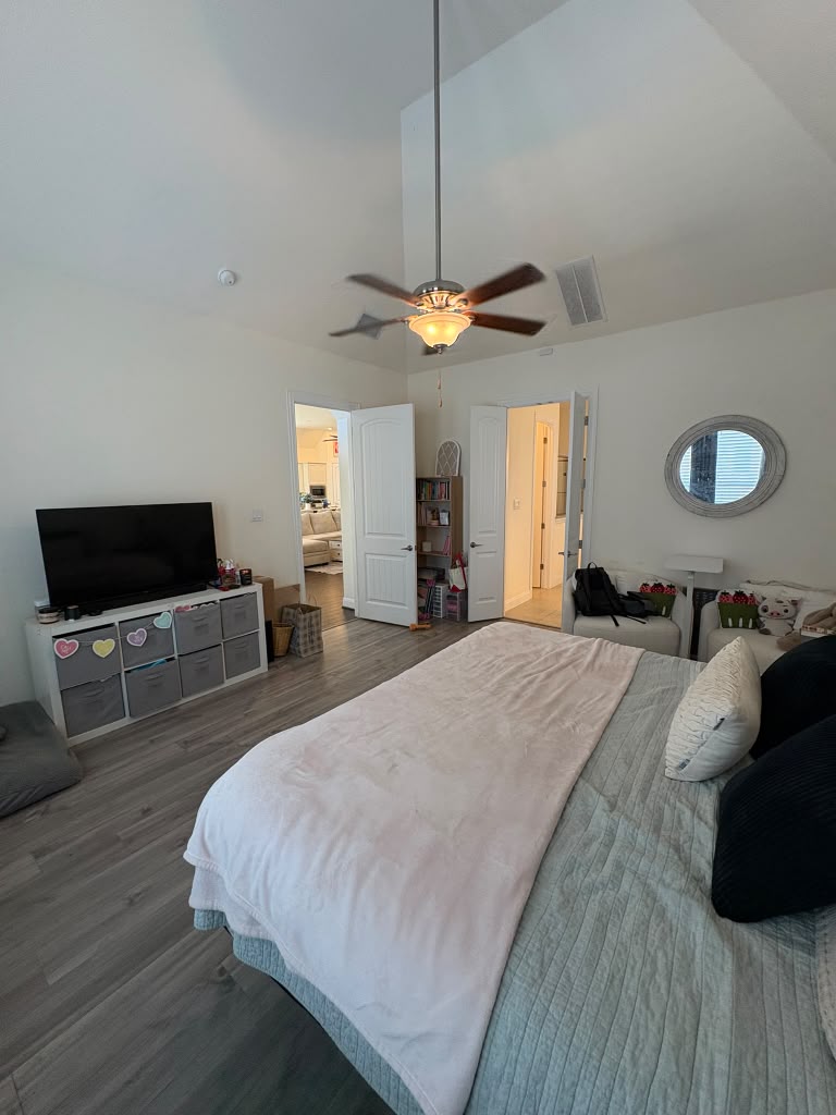 3812 Alpine Rdg Cove Leander, TX 78641 - Photo 25 of 37 A comfortable bedroom features high vaulted ceilings and durable wood-look flooring.