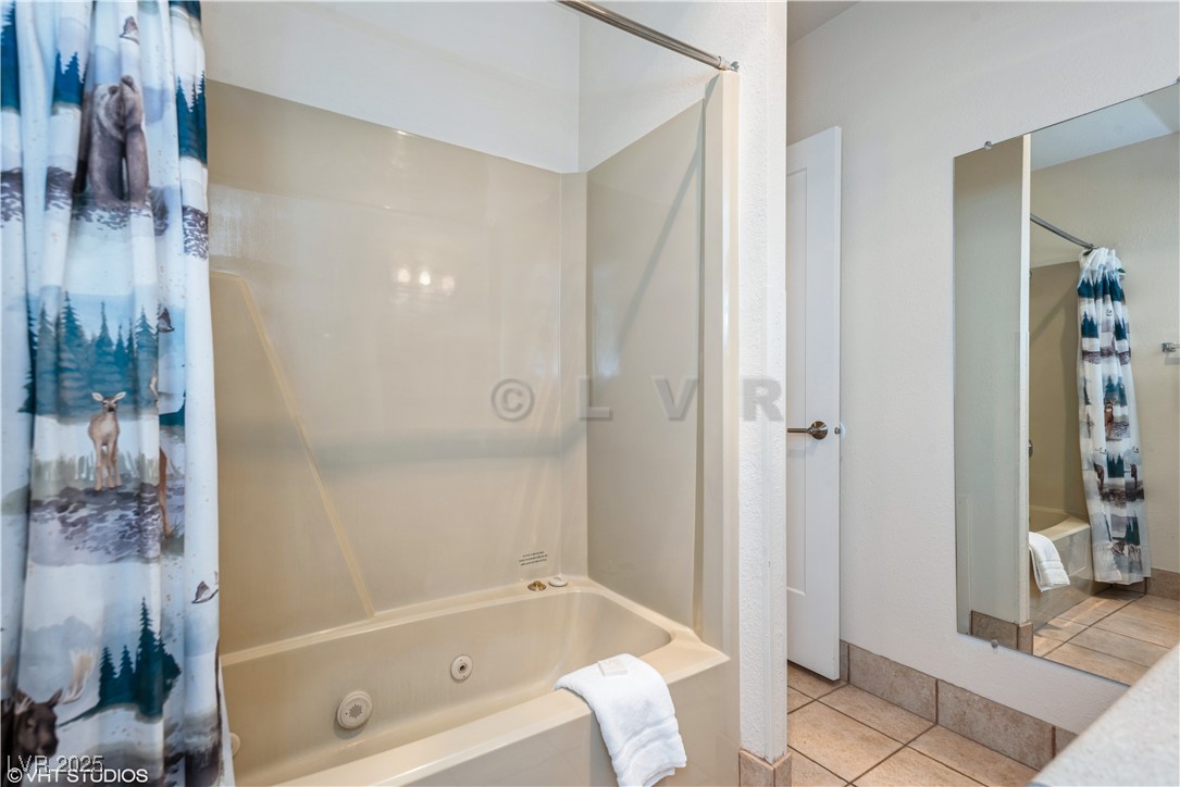 223 Hunter Ridge Drive, Unit 300 Brian Head, UT 84719 - Photo 16 of 48 Full bathroom featuring tile patterned flooring and a combined bath / shower with jetted tub