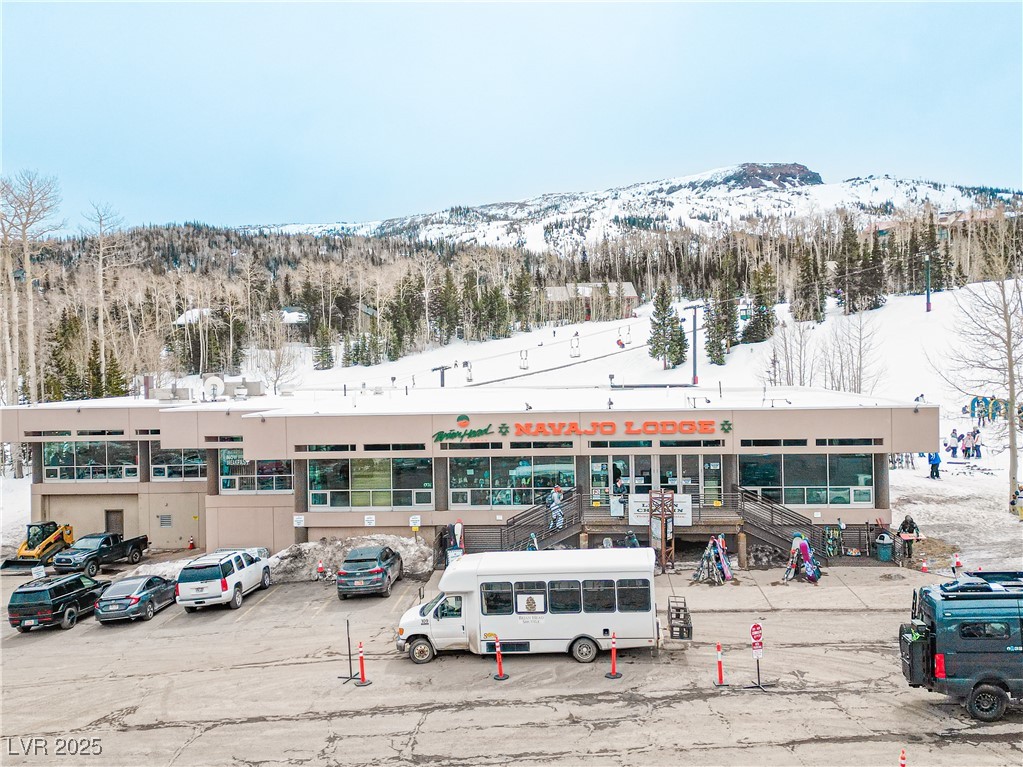 223 Hunter Ridge Drive, Unit 300 Brian Head, UT 84719 - Photo 42 of 48 Snow covered property with uncovered parking and a mountain view