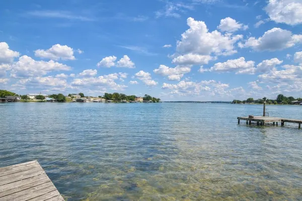 an aerial view of a house with a garden and lake view
