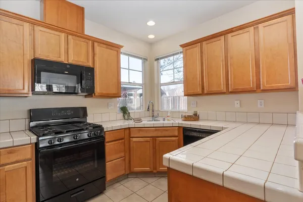 a kitchen with stainless steel appliances a stove sink microwave and cabinets