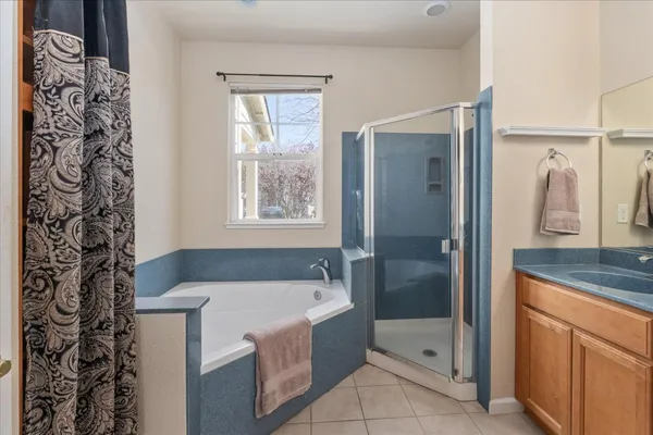 a bathroom with a tub sink and mirror