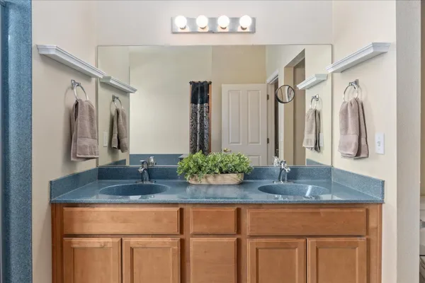 a bathroom with cabinets a sink and a mirror