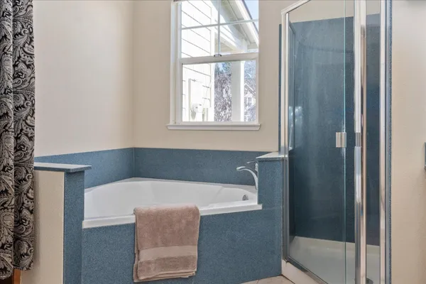 a bath tub sitting in a bathroom next to a window