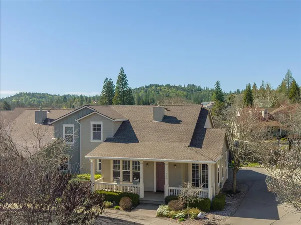 a aerial view of a house with a yard and balcony
