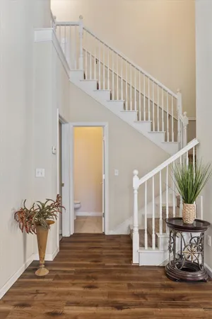 a view of entryway and hall with wooden floor