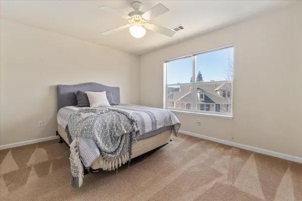 a bedroom with a bed and a window