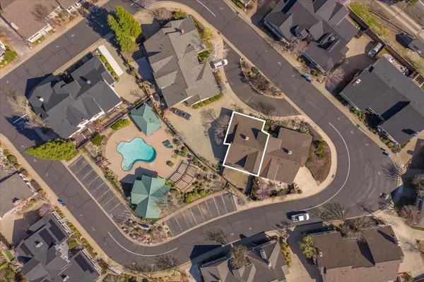 an aerial view of a house with a swimming pool