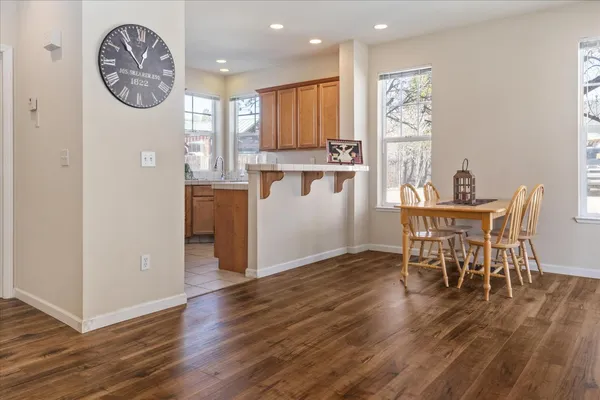 a view of a dining room with furniture and wooden floor
