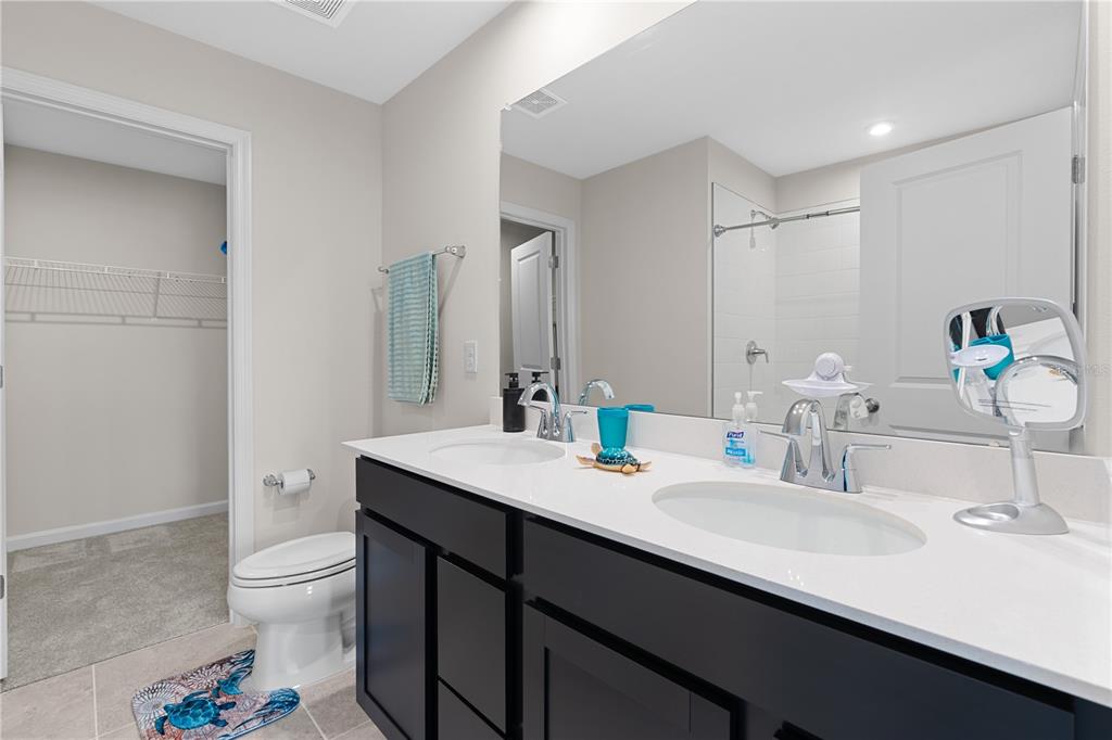 12003 Grizzly Lane New Port Richey, FL 34654 - Photo 29 of 43 a bathroom with a sink double vanity and a toilet