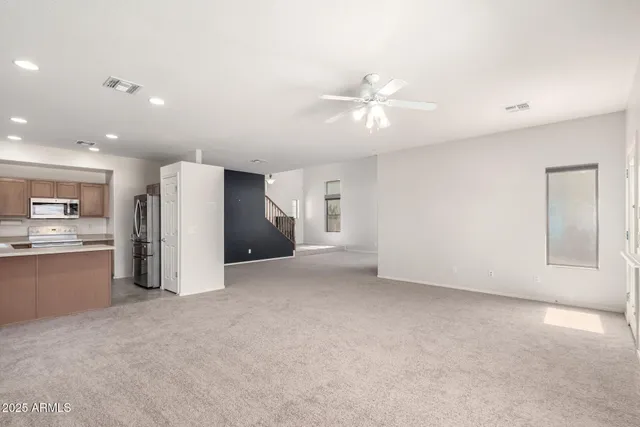 a view of an empty room with stairs