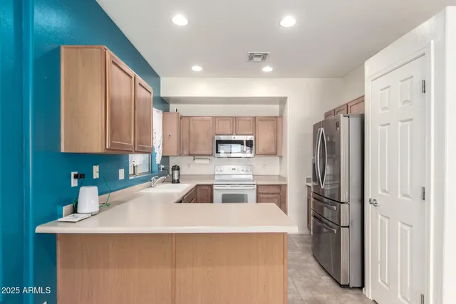 a view of an empty room with a kitchen
