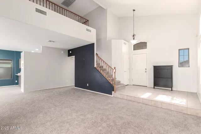 a picture of a rug with a white wall and a refrigerator