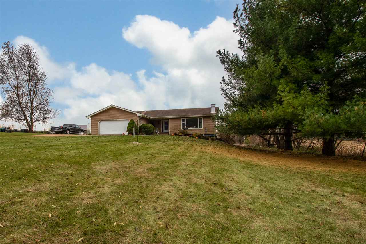 14500 Saunders Road Pecatonica, IL 61063 - Photo 1 of 19 a front view of a house with a yard and trees
