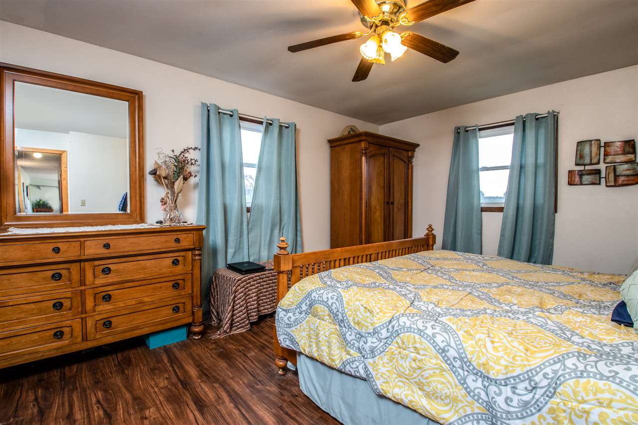 14500 Saunders Road Pecatonica, IL 61063 - Photo 12 of 19 a bedroom with a bed and a chandelier