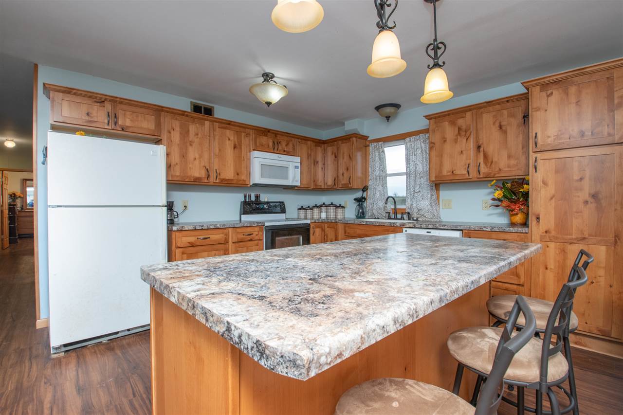 14500 Saunders Road Pecatonica, IL 61063 - Photo 9 of 19 a kitchen with stainless steel appliances granite countertop a sink refrigerator dining table and chairs