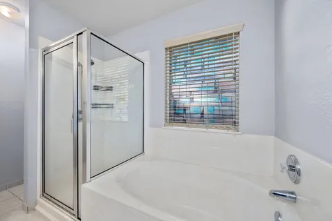 a bathroom with a bathtub and a shower