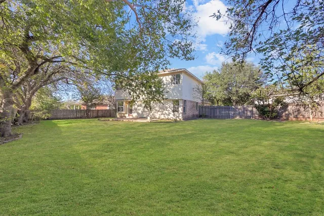 a view of yard with swimming pool and green space