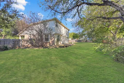 a view of a park with large trees