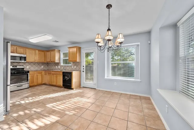 a view of a kitchen with a sink stainless steel appliances and cabinets