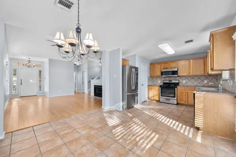 a kitchen with stainless steel appliances granite countertop a refrigerator and a sink