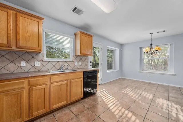 a spacious bathroom with stainless steel appliances granite countertop a sink and a window