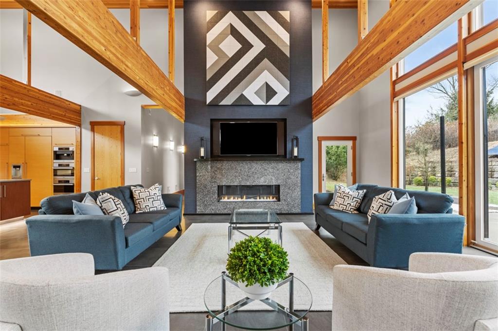999 Elmhurst Road Pittsburgh, PA 15215 - Photo 8 of 49 The living room features soaring ceilings, walls 30 ft windows, a beautiful fireplace that turns with the touch of a button.