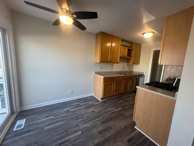 a kitchen with wooden floor and a stove top oven