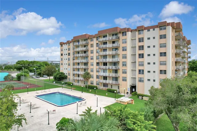 a view of a large building and a yard