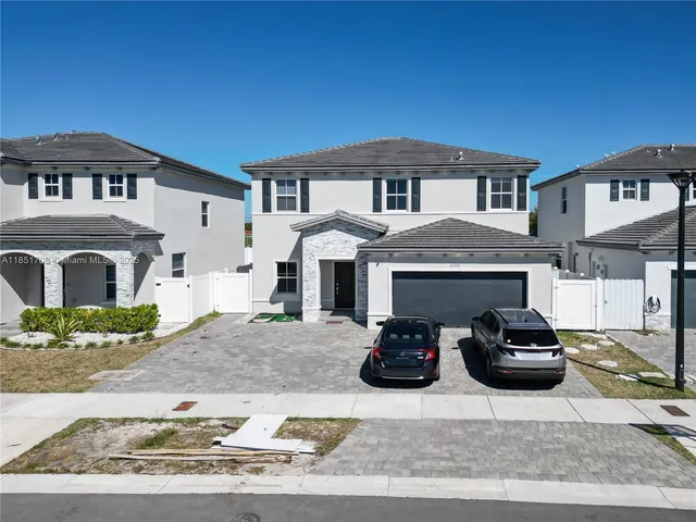 a front view of a house with parking space