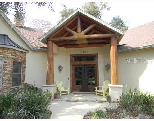 31053 Cove Road Tavares, FL 32778 - Photo 1 of 1 Exterior Front - Front entry with rope wrapped cypress beams and custom crafted double entry doors welcome your guests into this truly unique custom home