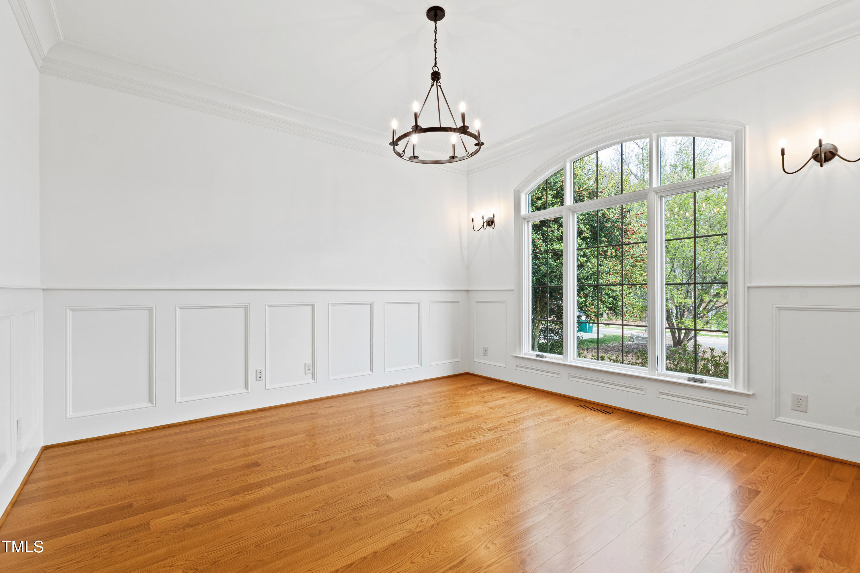 8108 Harps Mill Road Raleigh, NC 27615 - Photo 11 of 64 a view of an empty room with wooden floor and a window
