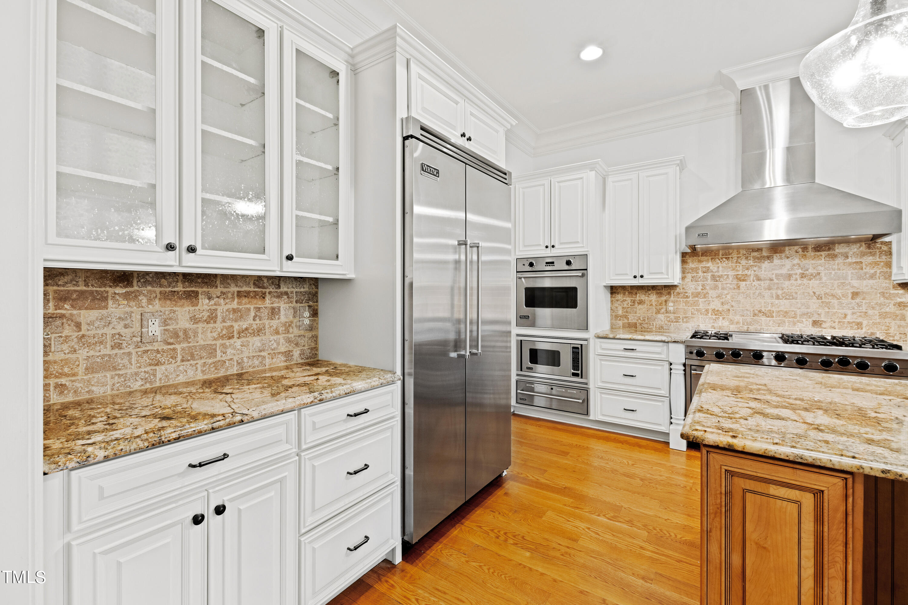 8108 Harps Mill Road Raleigh, NC 27615 - Photo 14 of 64 a kitchen with stainless steel appliances granite countertop a stove and a refrigerator