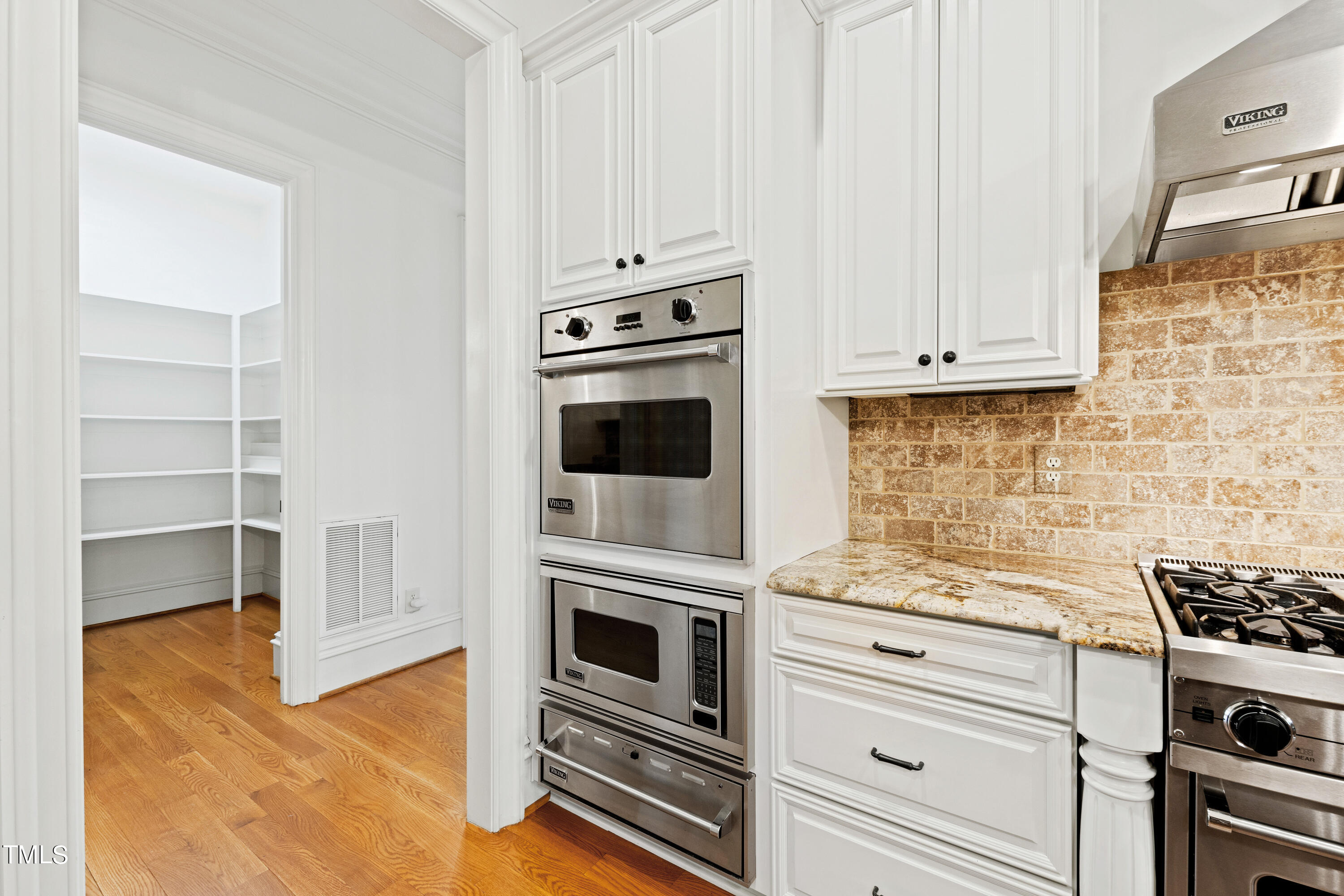 8108 Harps Mill Road Raleigh, NC 27615 - Photo 18 of 64 a kitchen with cabinets and appliances
