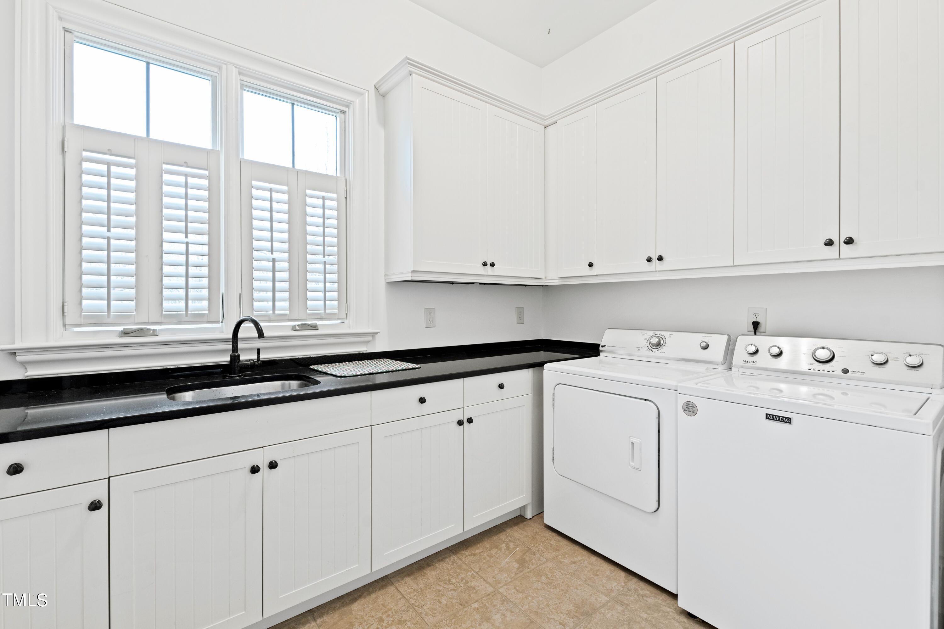 8108 Harps Mill Road Raleigh, NC 27615 - Photo 21 of 64 a view of cabinets with washing machine