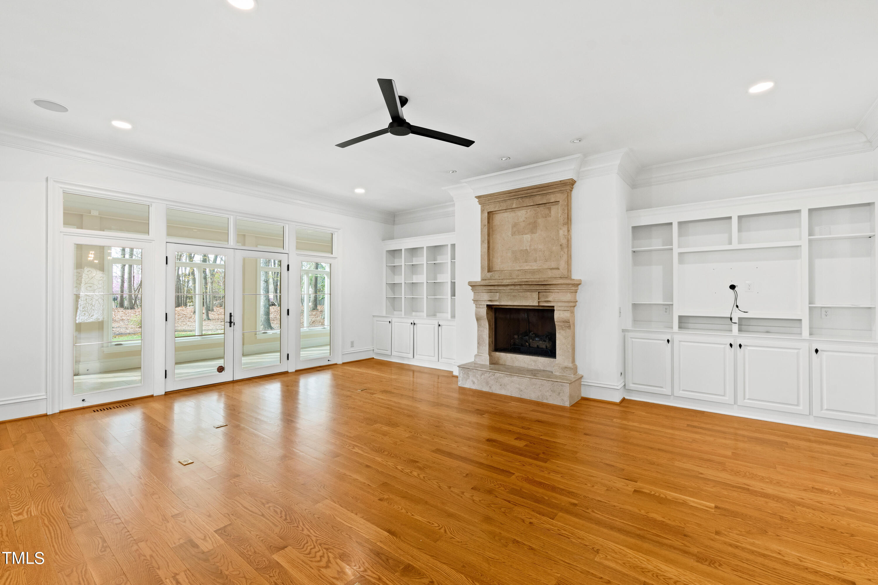 8108 Harps Mill Road Raleigh, NC 27615 - Photo 23 of 64 a view of an empty room with wooden floor and a window