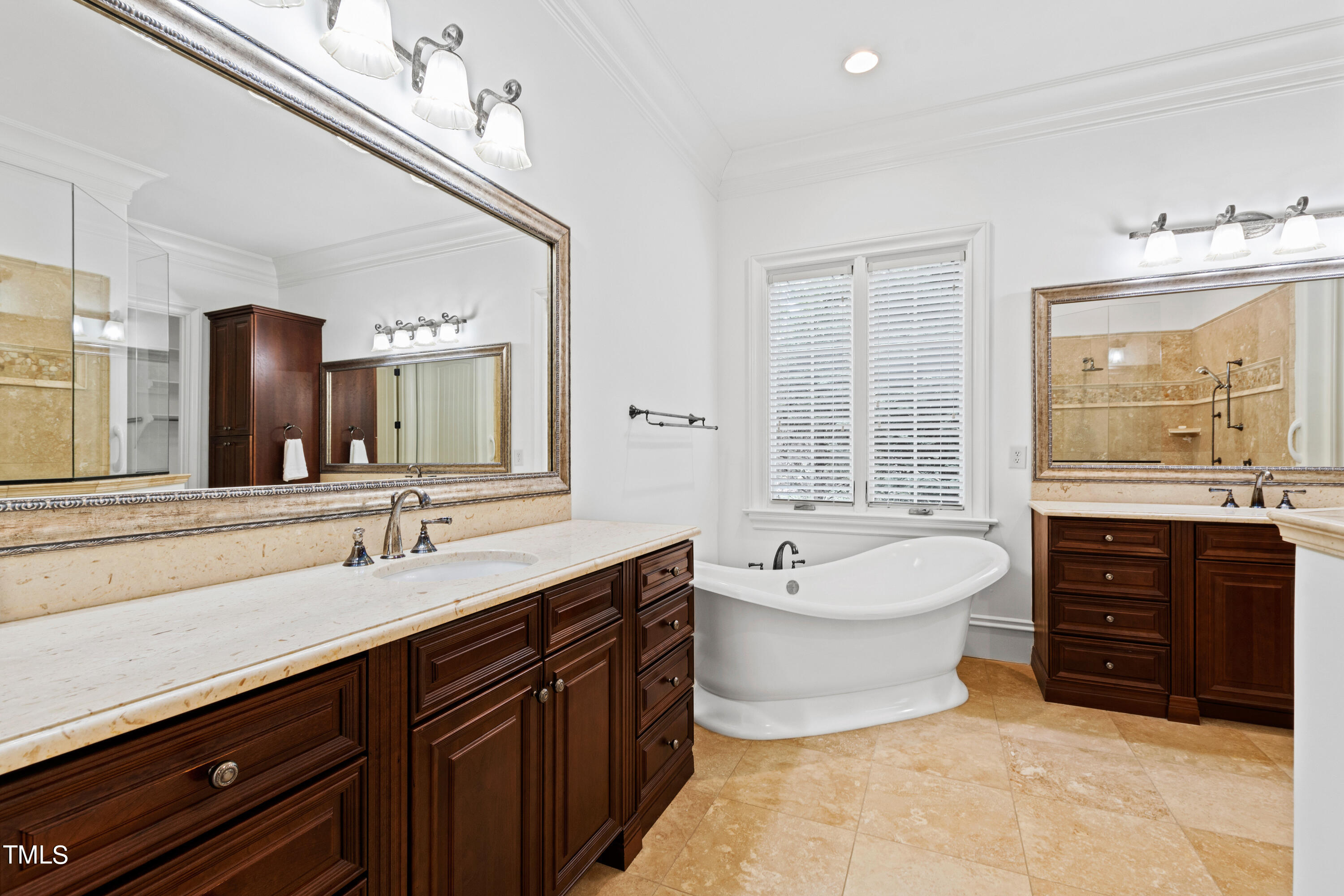 8108 Harps Mill Road Raleigh, NC 27615 - Photo 30 of 64 a spacious bathroom with a tub sink double vanity and mirror