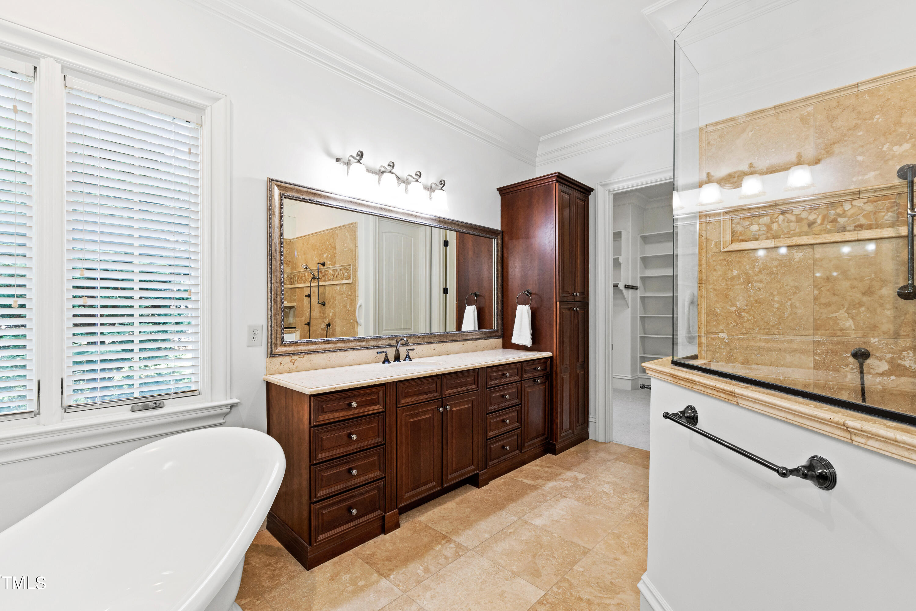 8108 Harps Mill Road Raleigh, NC 27615 - Photo 31 of 64 a spacious bathroom with a granite countertop tub sink a mirror a shower and vanity