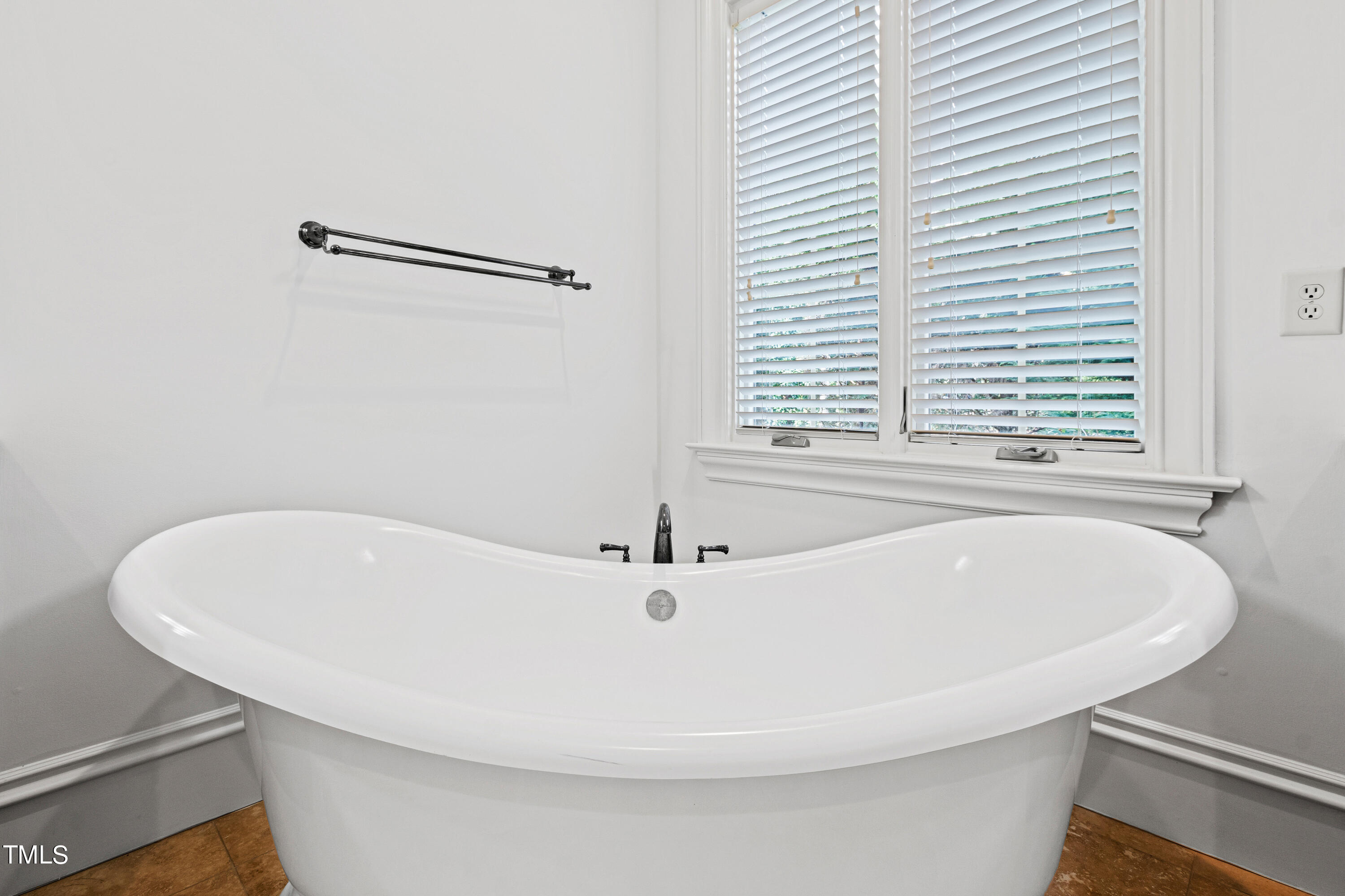 8108 Harps Mill Road Raleigh, NC 27615 - Photo 32 of 64 a white bath tub sitting in a bathroom