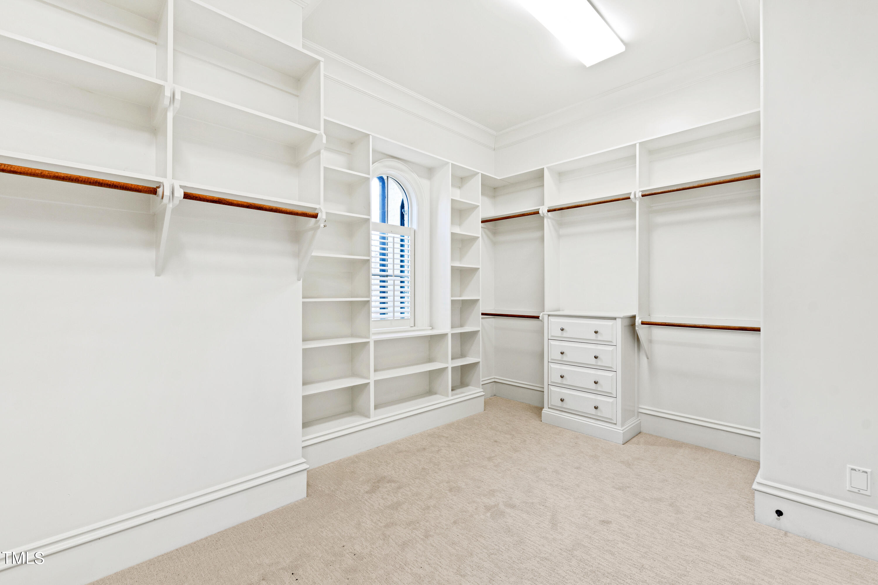 8108 Harps Mill Road Raleigh, NC 27615 - Photo 34 of 64 a view of walk in closet with empty racks