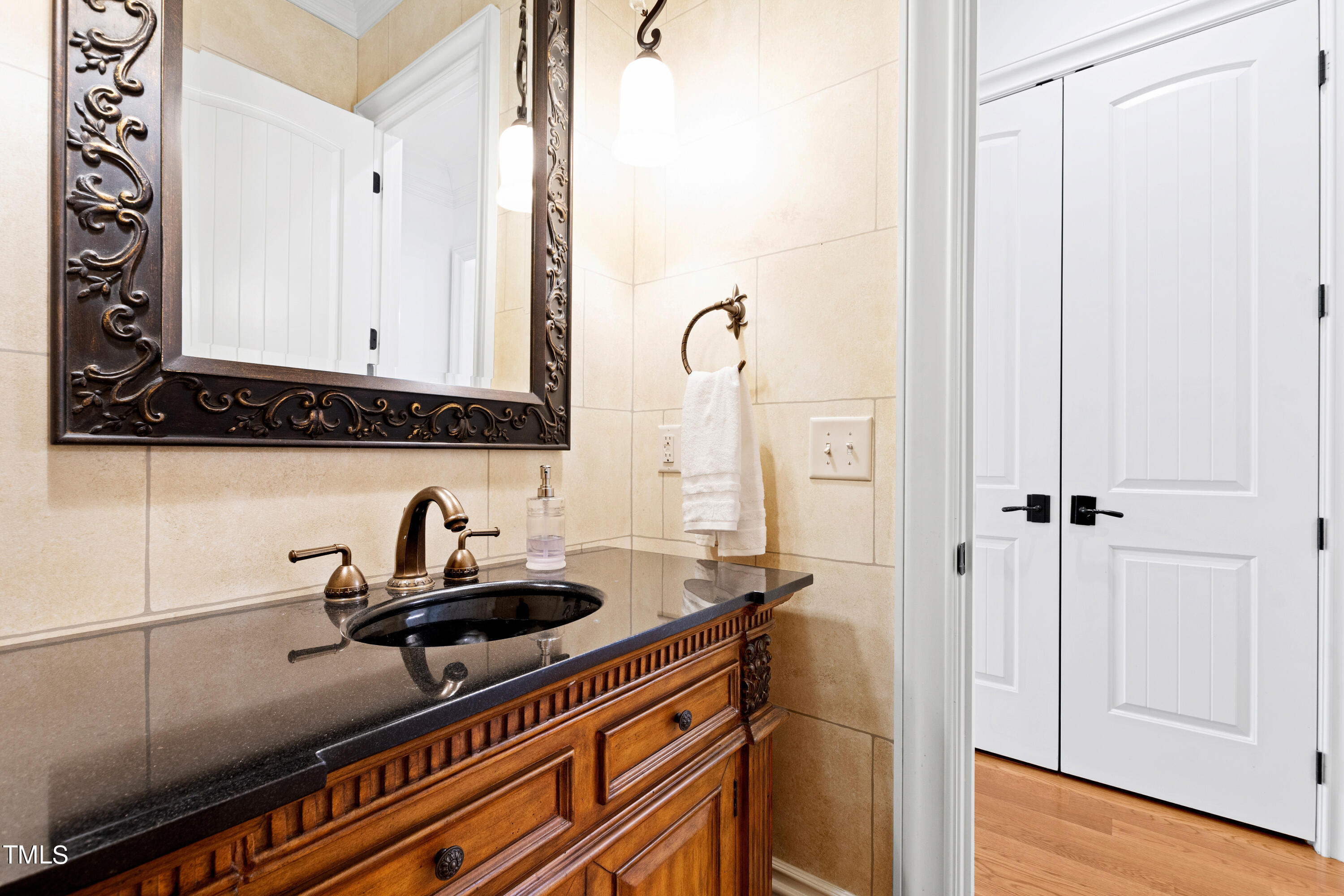 8108 Harps Mill Road Raleigh, NC 27615 - Photo 43 of 64 a bathroom with a sink and a mirror