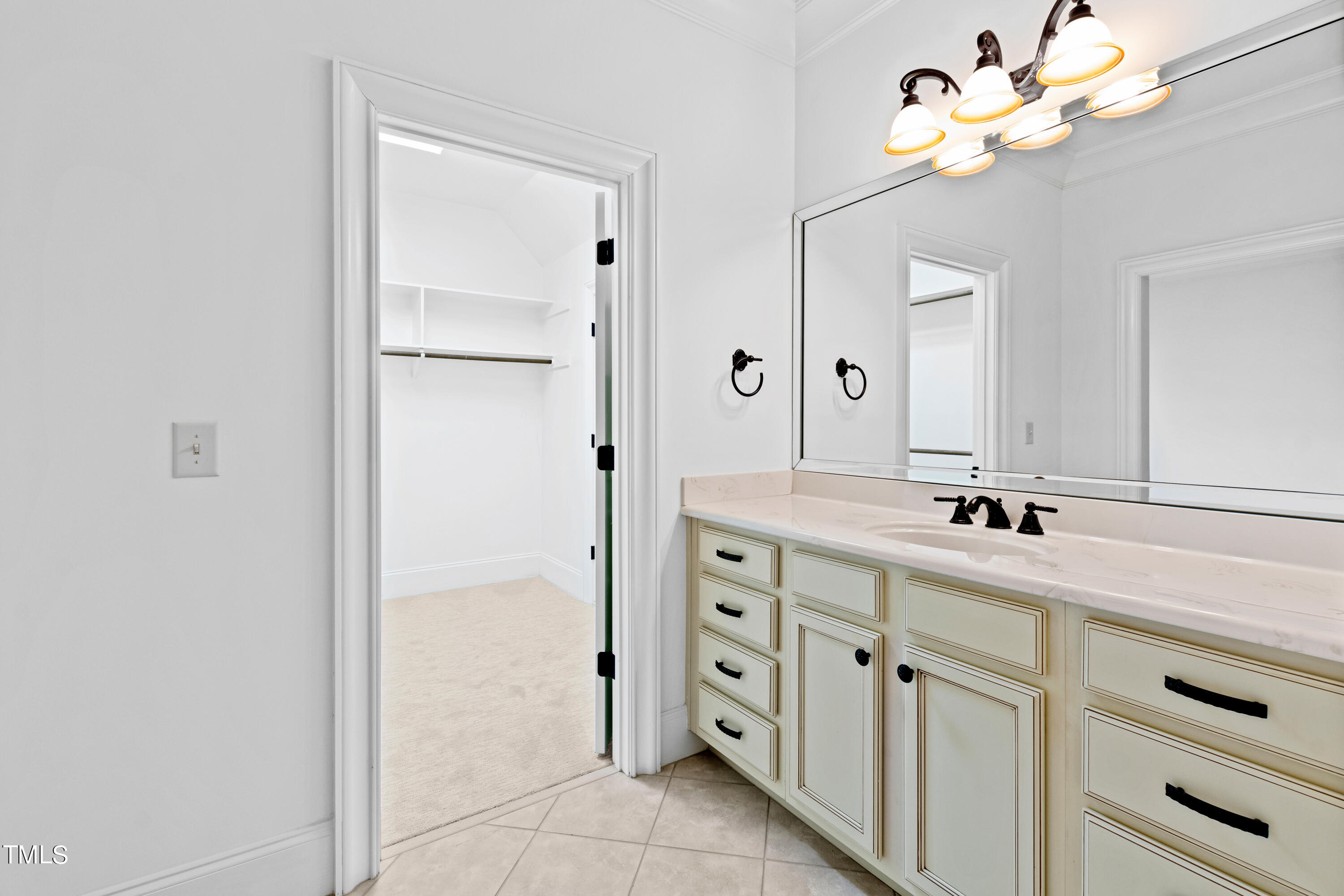 8108 Harps Mill Road Raleigh, NC 27615 - Photo 44 of 64 a bathroom with a sink vanity and a mirror