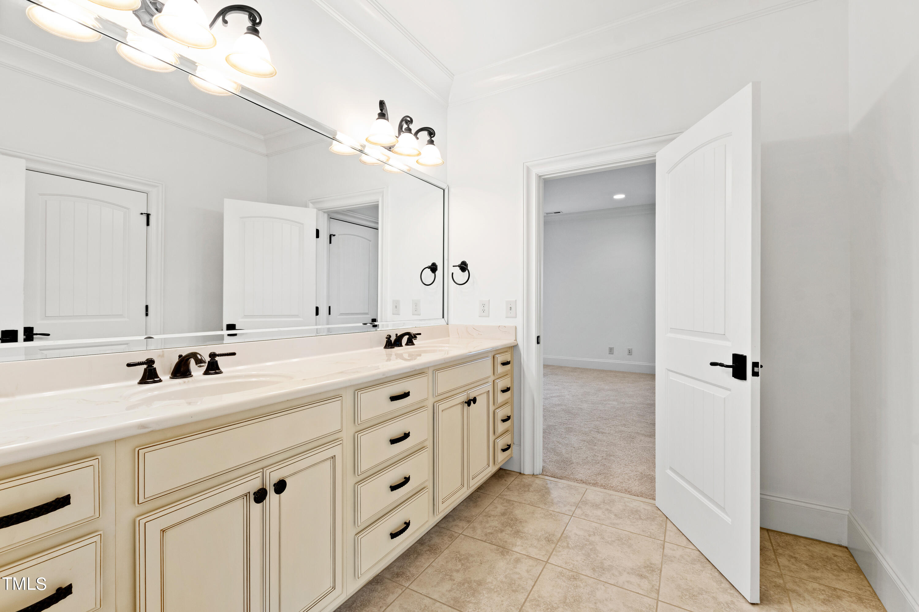 8108 Harps Mill Road Raleigh, NC 27615 - Photo 46 of 64 a bathroom with a double vanity sink mirror and