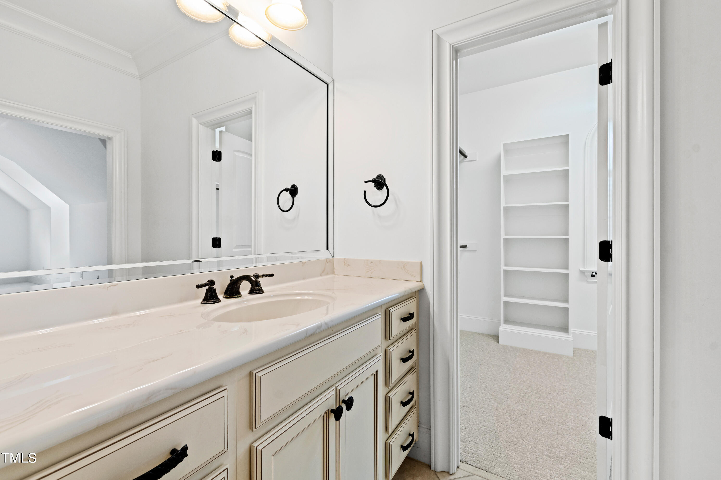 8108 Harps Mill Road Raleigh, NC 27615 - Photo 47 of 64 a bathroom with a sink and a mirror