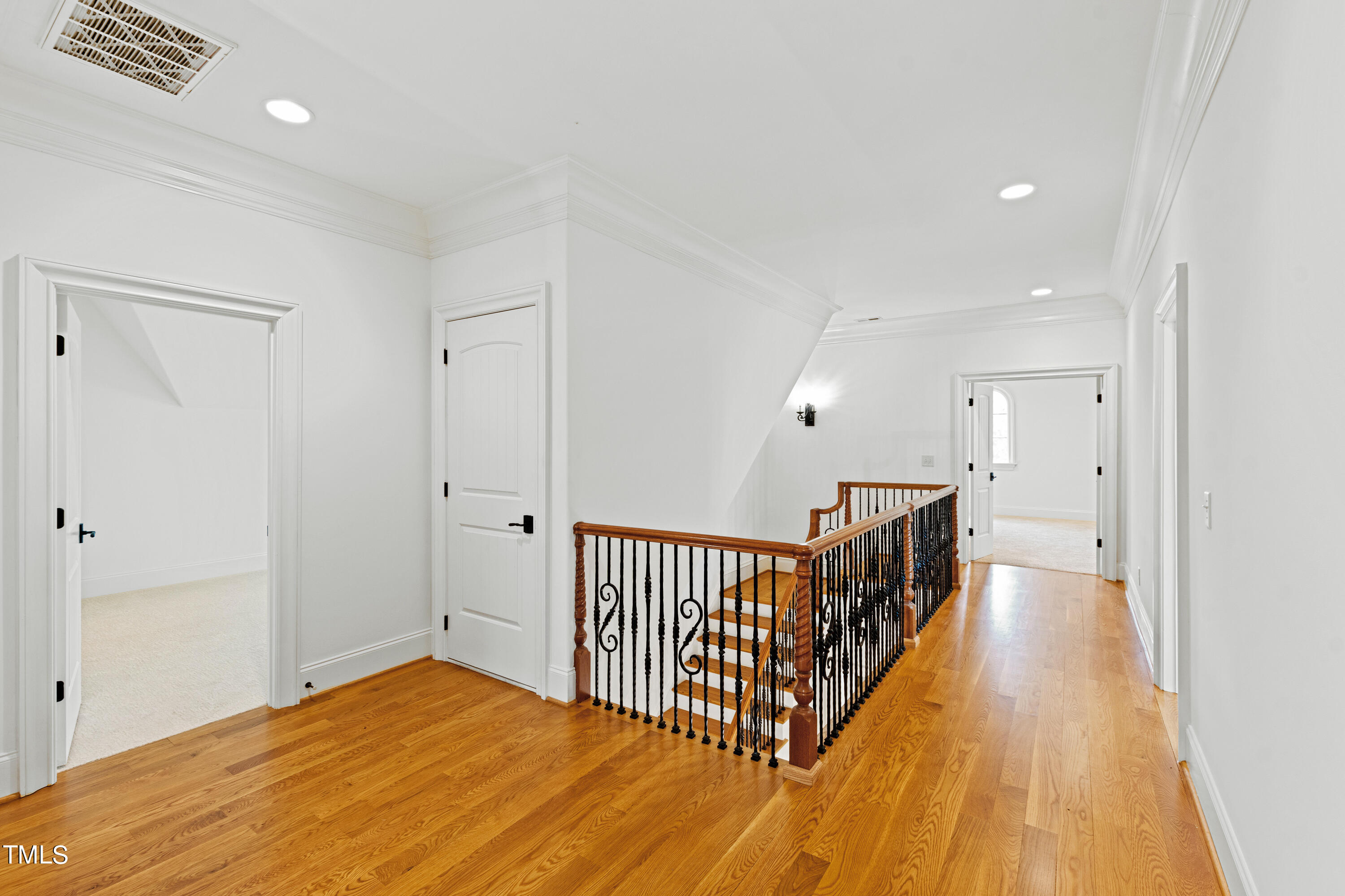 8108 Harps Mill Road Raleigh, NC 27615 - Photo 48 of 64 a view of a hallway with wooden floor