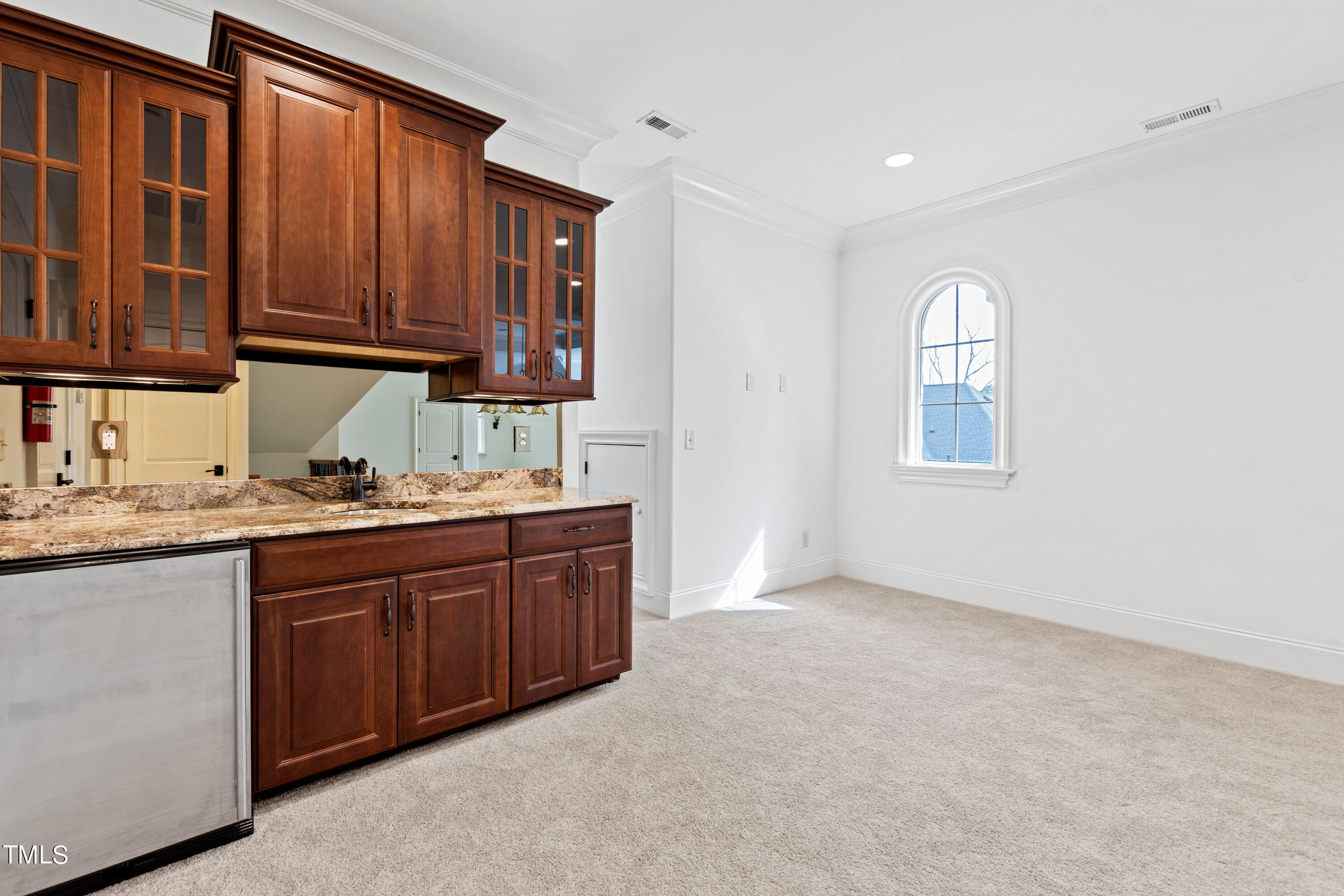 8108 Harps Mill Road Raleigh, NC 27615 - Photo 51 of 64 a kitchen with granite countertop wooden cabinets stainless steel appliances a sink and a window